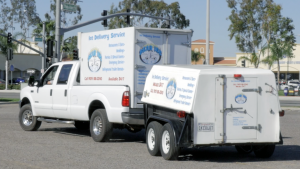 Bear Ice delivery service truck with a refrigerated container hauling a refrigerated trailer